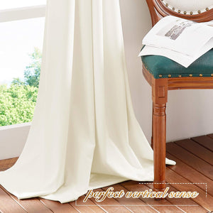 Cream floor-length drapes with a smooth, elegant drape by a bright window.