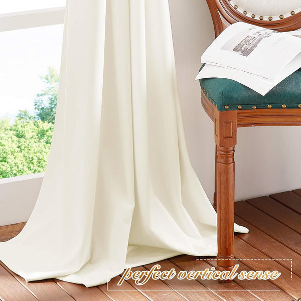 Cream floor-length drapes with a smooth, elegant drape by a bright window.