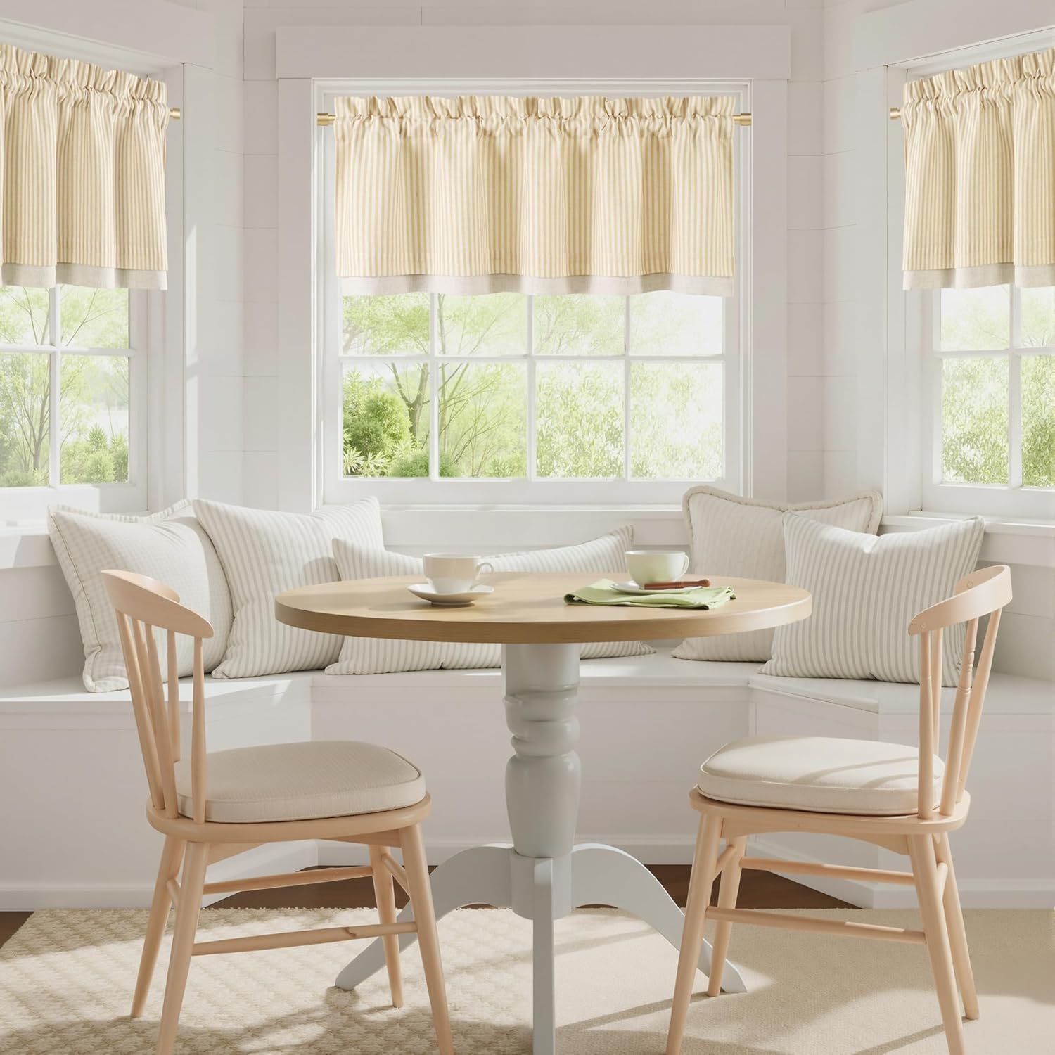 Cream and light yellow striped cafe valance with gathered top and solid border in a cozy kitchen dining nook.