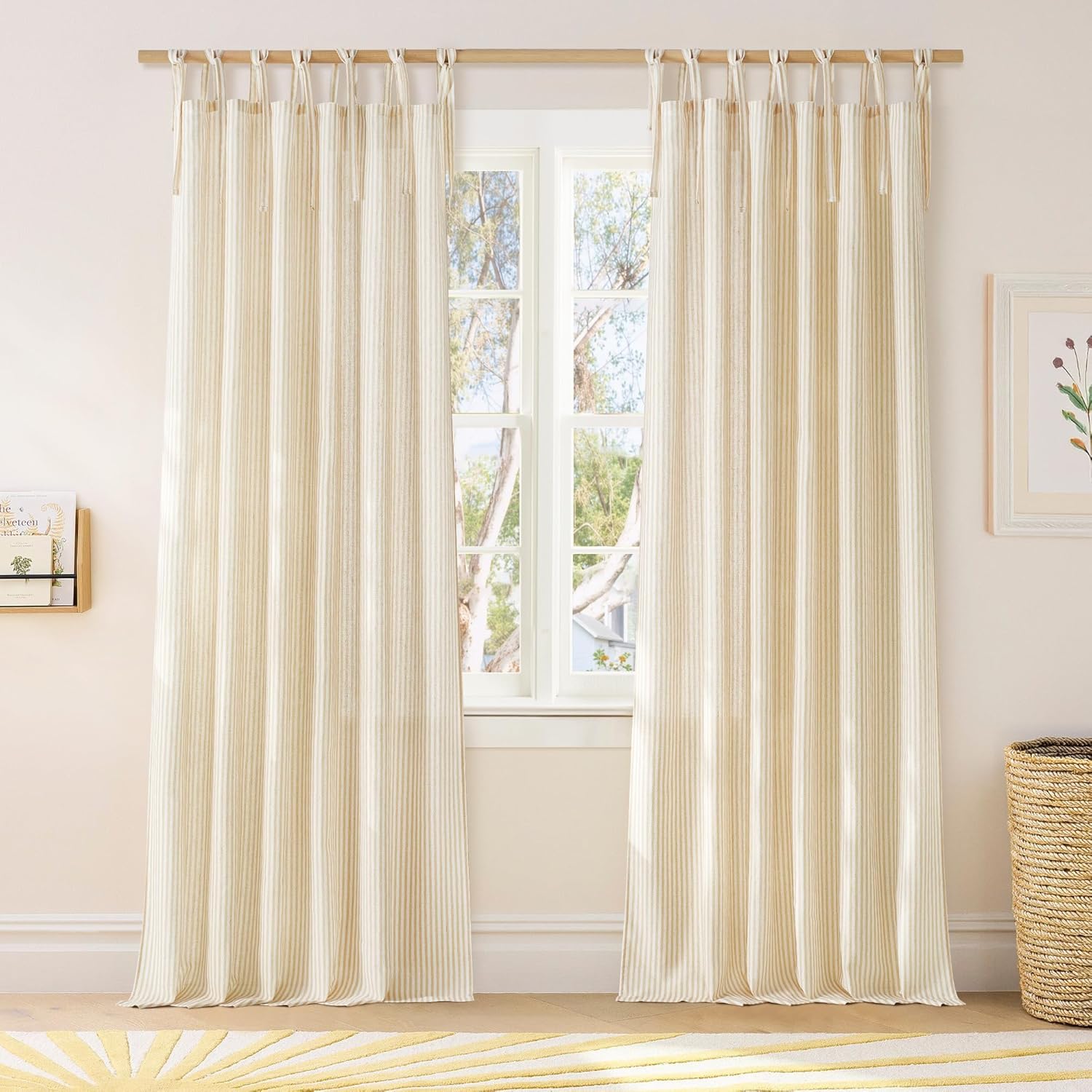 Cream and beige striped tie-top window curtains with a light texture, hanging on a wooden rod.