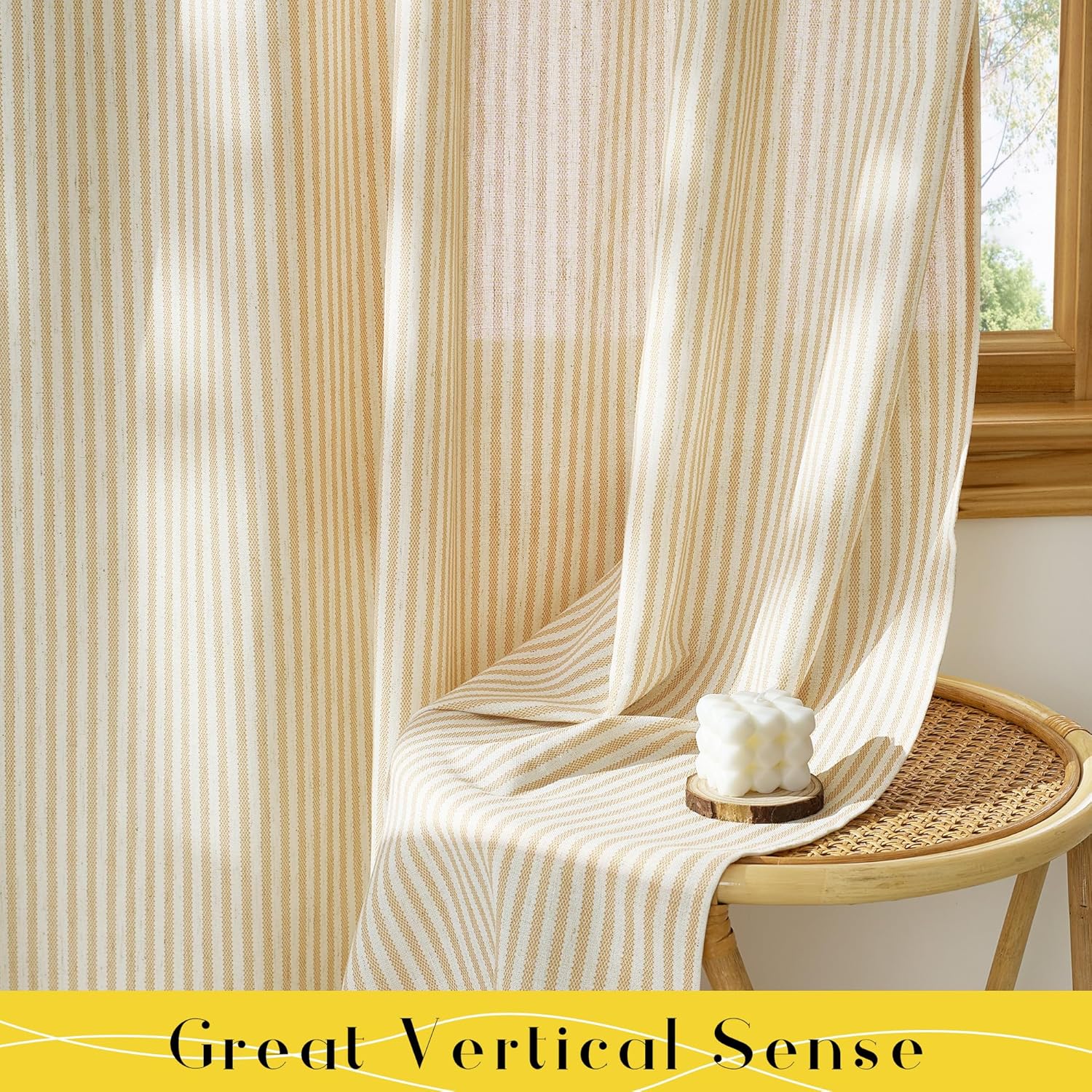 Textured cream and tan vertical striped curtains with natural light filtering through, draped on a woven rattan stool.