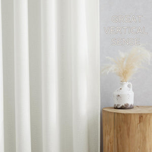 Cream textured linen blend curtain with elegant vertical pleats in a bright room.