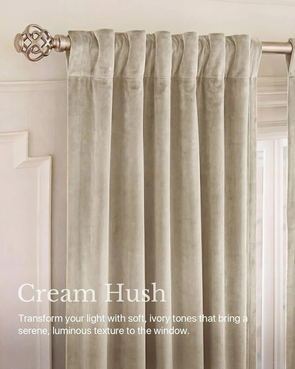 Cream velvet curtain panel with rod pocket header on a brushed brass curtain rod