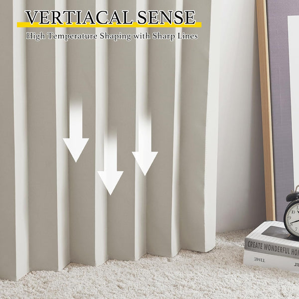 Close-up of cream vertical pleated fabric curtain with sharp folds, resting on a soft white shaggy rug.