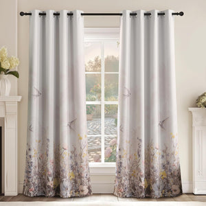 Cream grommet top curtains with an ombre wildflower garden and flying bird pattern.