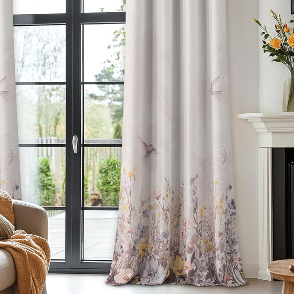 Full-length cream curtains with a graceful wildflower and flying bird pattern.