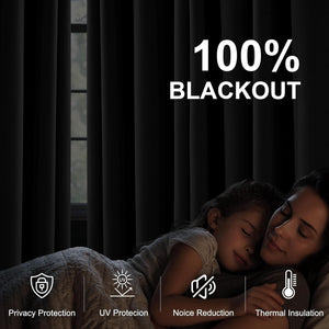 Dark blackout curtains cover a window, creating a dim room where a mother and child sleep peacefully.