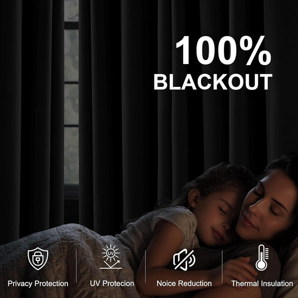 Dark blackout curtains cover a window, creating a dim room where a mother and child sleep peacefully.