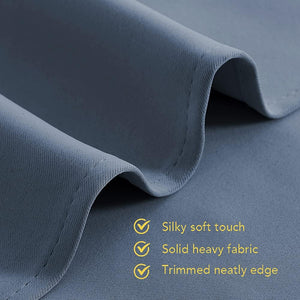 Dark blue fabric close-up with soft touch, solid heavy material, and neatly stitched edge.