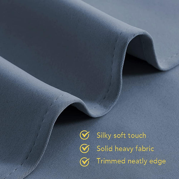 Dark blue fabric close-up with soft touch, solid heavy material, and neatly stitched edge.