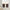 Dark brown linen-blend cafe curtains with pleated tops on a brass rod, covering the lower half of a window.