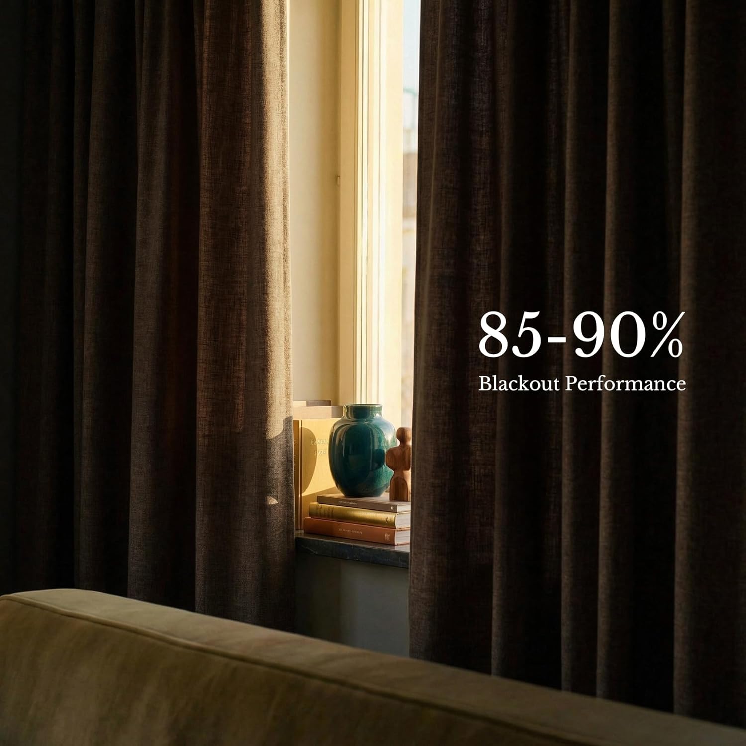 Dark brown textured blackout curtains hung over sunlit window, demonstrating 85-90% light blocking.