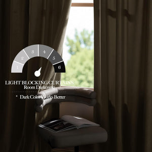 Dark brown velvet blackout curtains hanging by a window, providing strong room darkening.