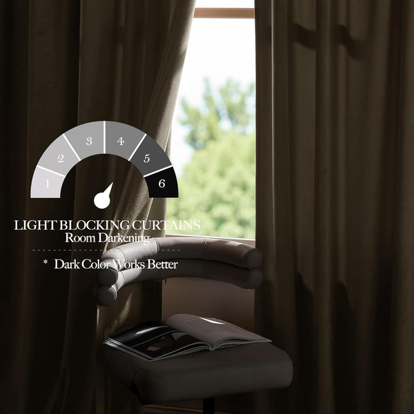 Dark brown velvet blackout curtains hanging by a window, providing strong room darkening.