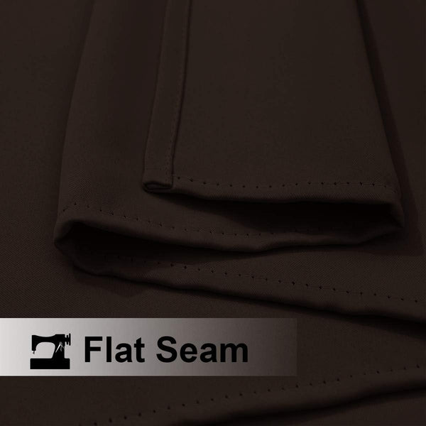 Close-up of dark brown woven fabric demonstrating a neat flat seam construction with visible stitching.