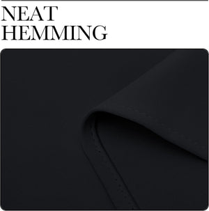 Close-up of dark black fabric showing a neatly sewn, double-stitched hem detail.