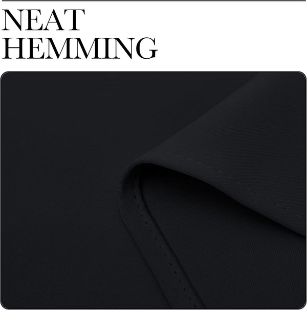 Close-up of dark black fabric showing a neatly sewn, double-stitched hem detail.