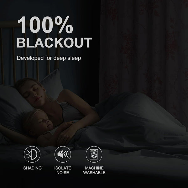 Floral blackout curtains creating a completely dark room where a mother and baby sleep soundly.