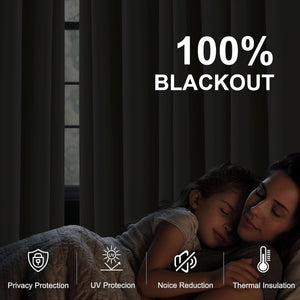 Dark gray 100% blackout curtains drawn shut, creating a dim room where a mother and child sleep peacefully.
