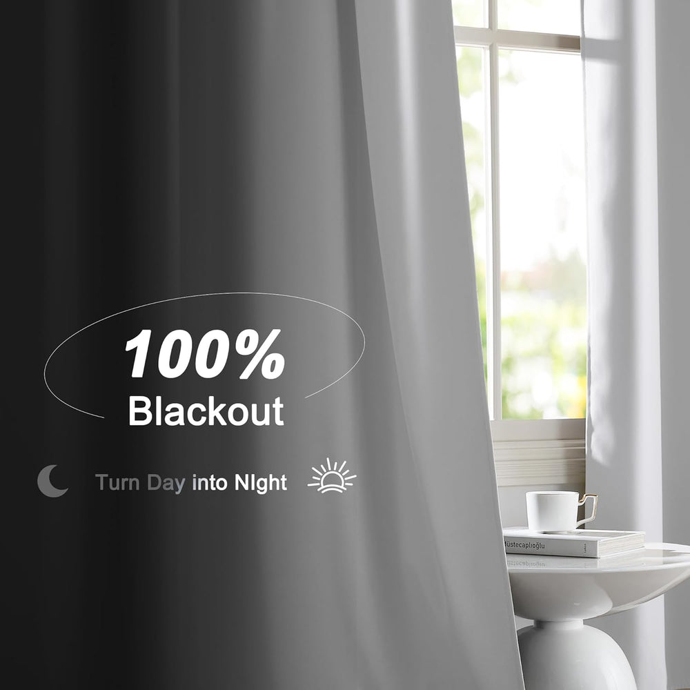 Two white blackout back tab curtains hanging on a black rod in a bright room, one curtain pulled back revealing black lining.