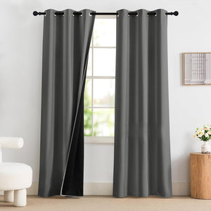 Dark gray blackout curtains with grommet top on black rod. One panel slightly open, revealing opaque lining.