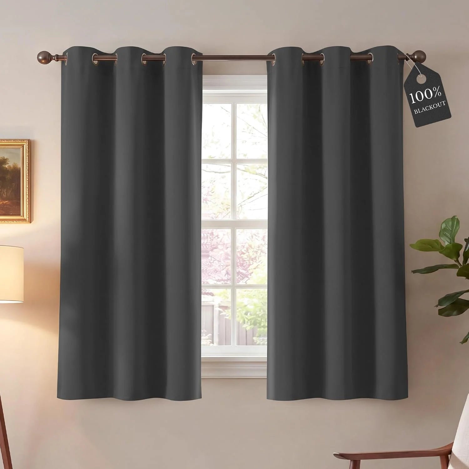Dark gray blackout curtains with grommet top in a bright living room setting