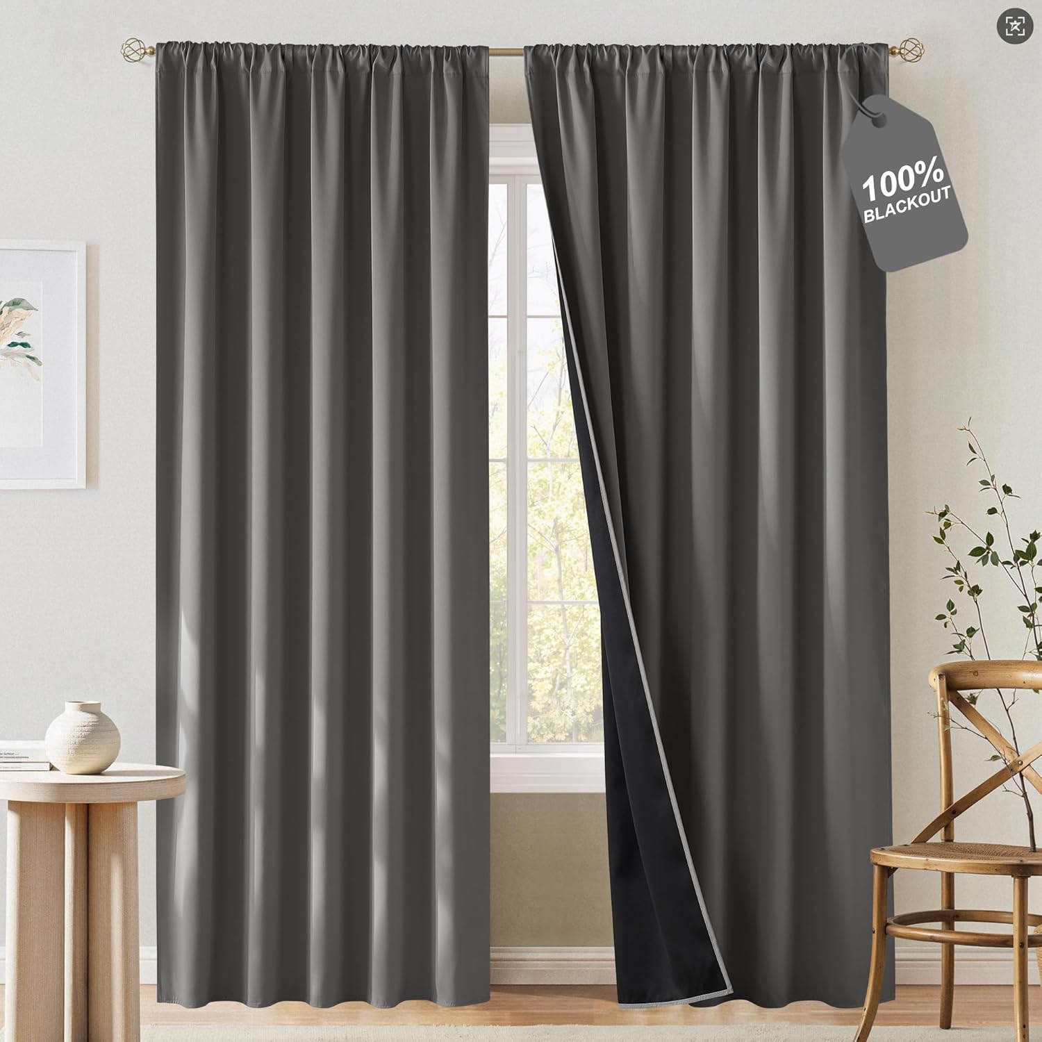 Dark gray blackout curtains with gathered rod pocket top, partially open to reveal black lining.