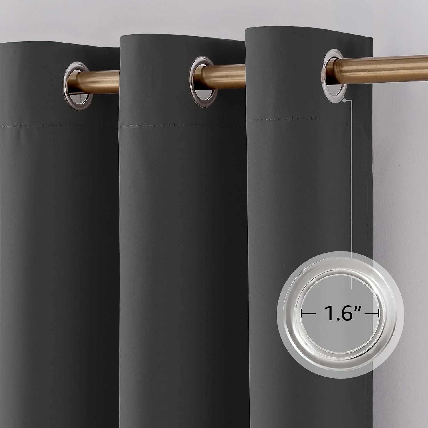 Close-up of a dark gray grommet curtain showing a 1.6 inch inner diameter grommet on a gold rod.