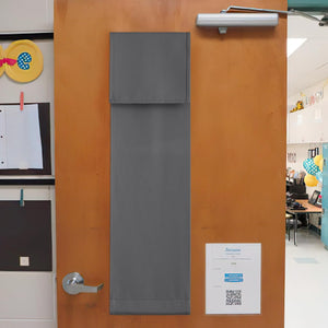 Dark gray rectangular fabric door privacy cover with visible stitching, hung on a wooden classroom door.