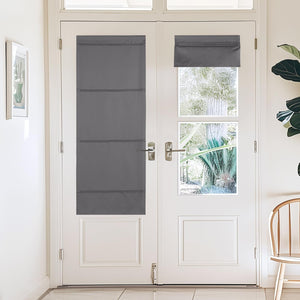 Dark gray fabric privacy shades mounted on white French door glass. One full-length, one rolled up.