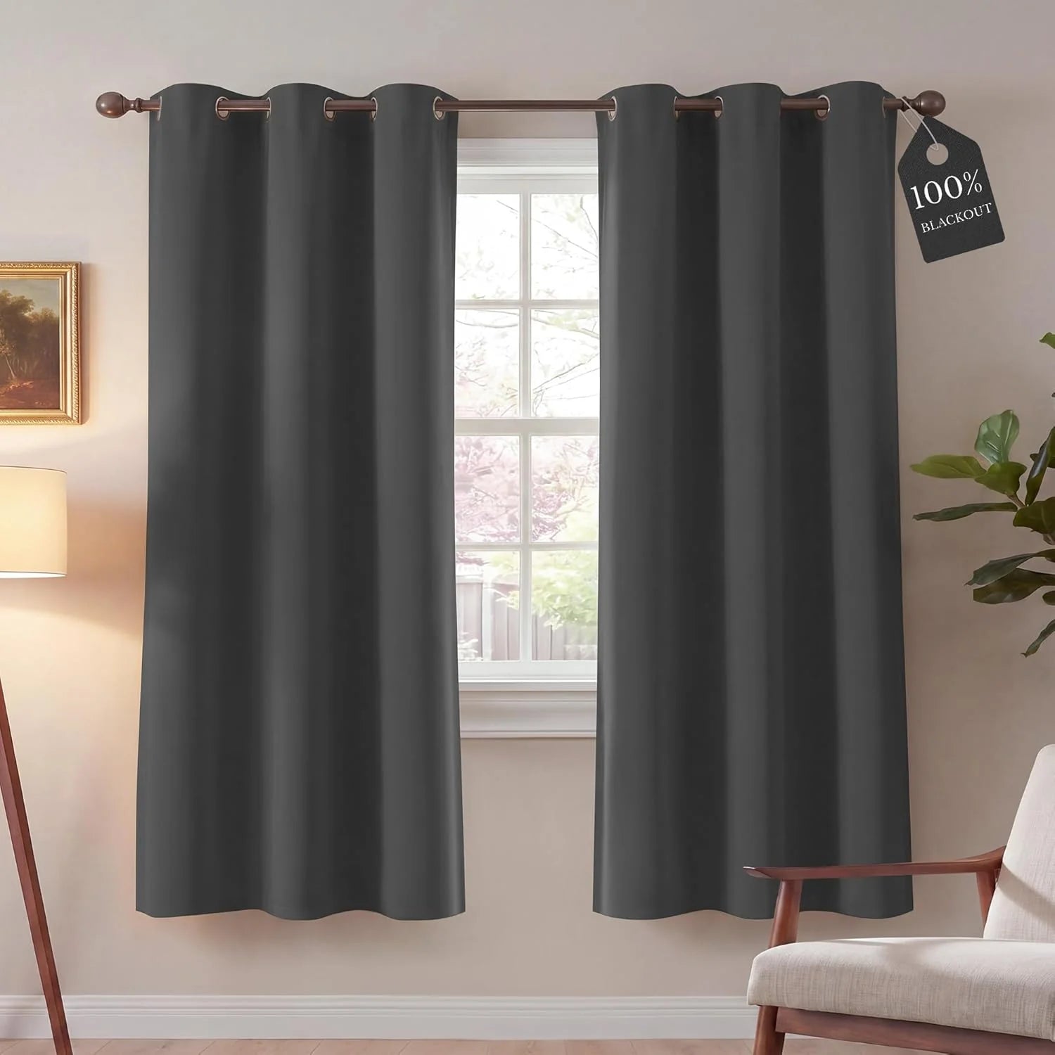 Dark gray grommet top blackout curtains over a window in a cozy room