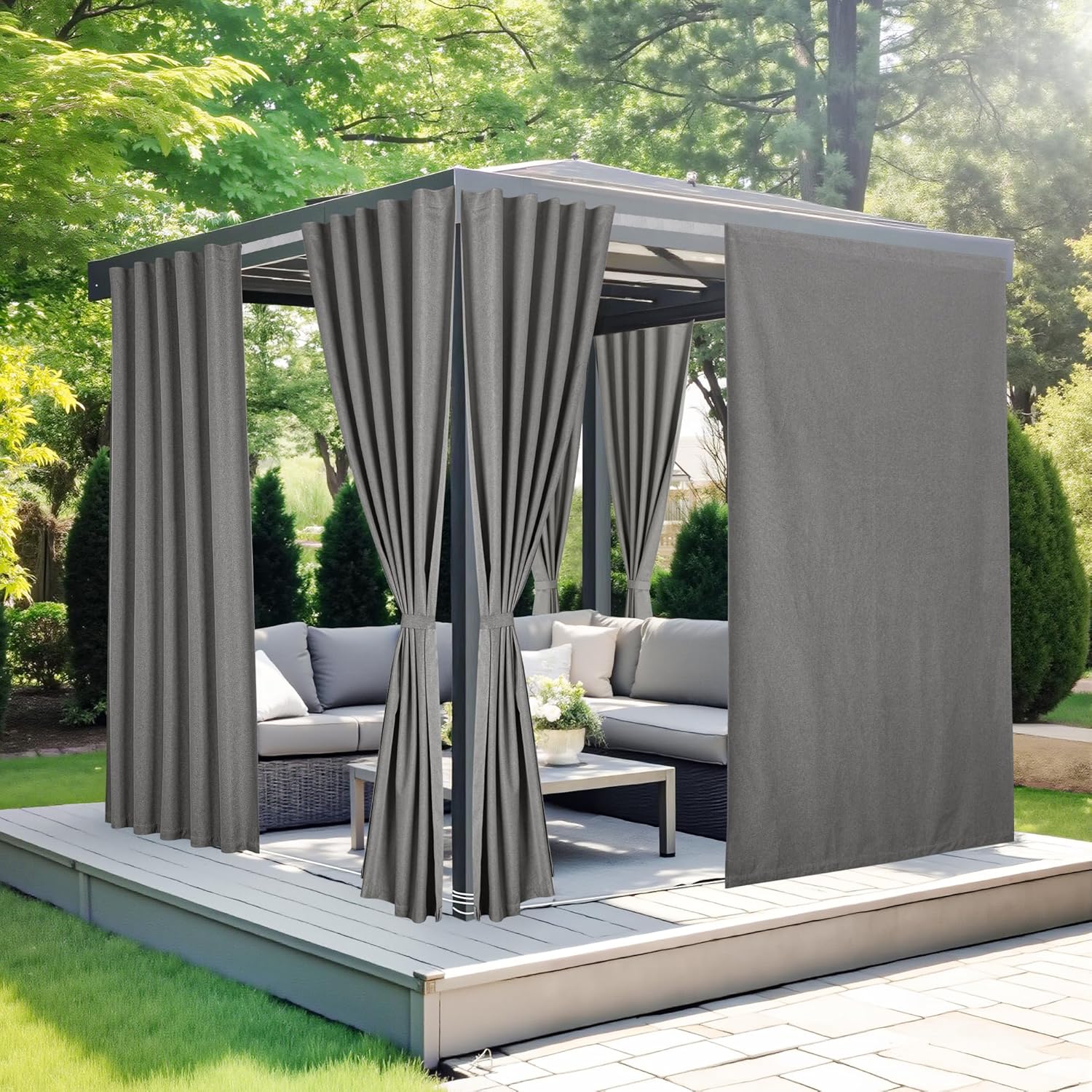Modern dark gray outdoor gazebo with privacy curtains. Two curtains tied back, one closed, on a gray wooden deck.
