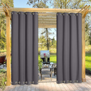 Dark gray outdoor grommet top curtains installed on a wooden pergola, offering privacy for a sunny patio.
