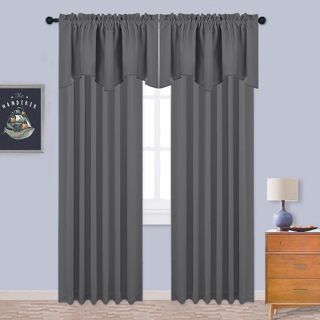 Two dark gray rod pocket curtains with integrated wavy valance hanging on a black rod.