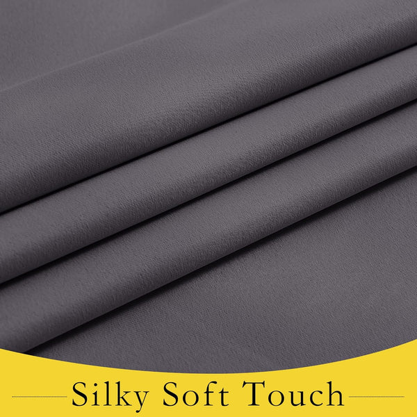 Detailed view of charcoal gray fabric with a fine weave and soft, draping folds, highlighting its silky texture.