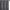 Dark gray curtain panel with silver wavy pattern, black grommet top, hanging on a rod.