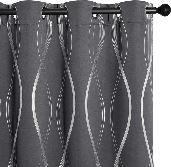 Dark gray curtain panel with silver wavy pattern, black grommet top, hanging on a rod.