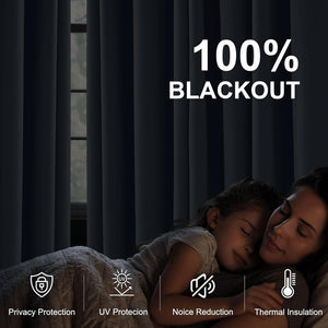 Dark gray 100% blackout curtains in a bedroom, creating complete darkness for a sleeping woman and child.