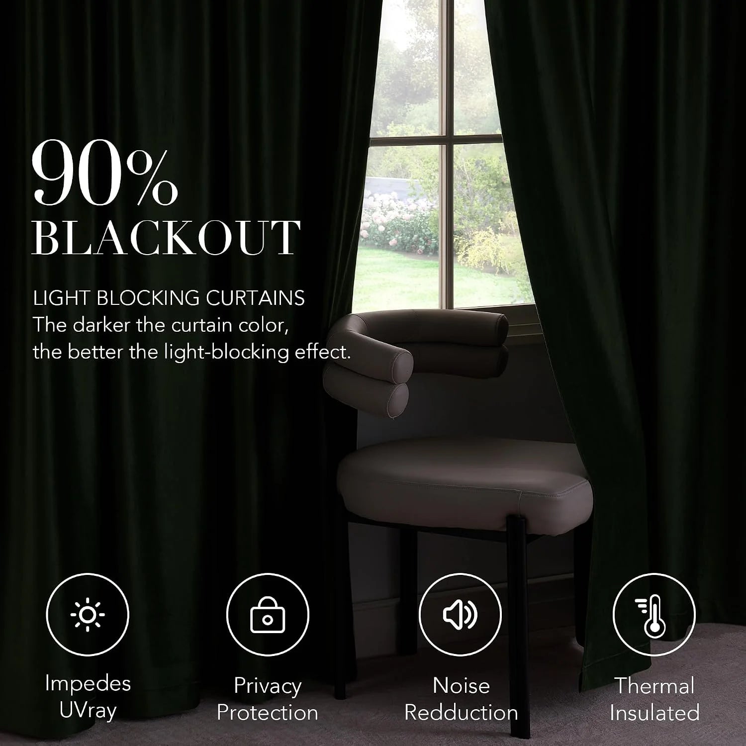 Dark green blackout curtains framing a window beside a modern upholstered chair
