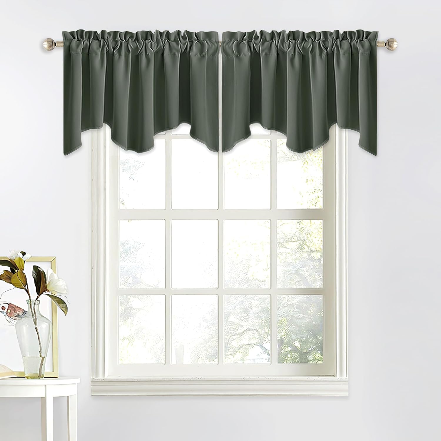 Solid dark green gathered valance with a scalloped hem covering the top of a white-framed window.