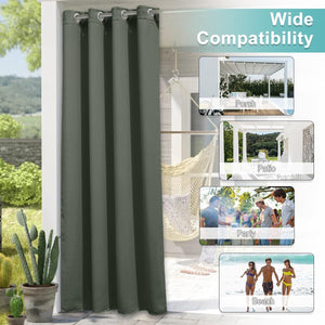 Dark green outdoor curtain panel with silver grommets hanging on a patio