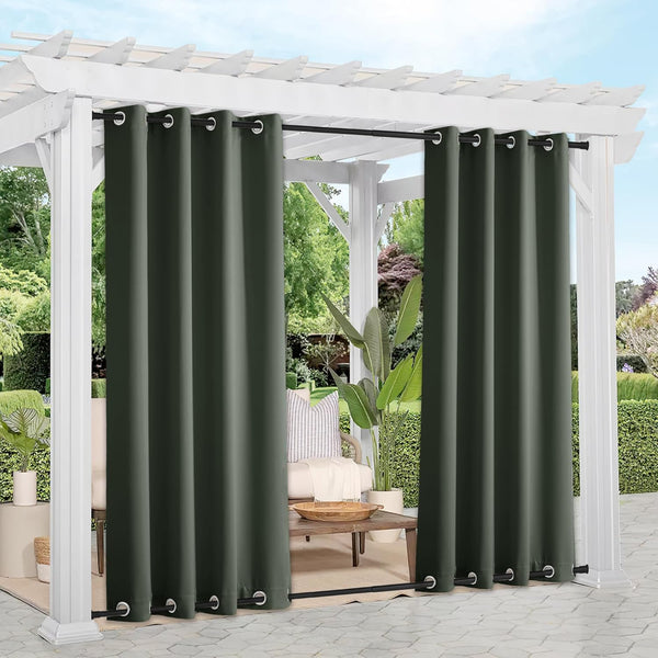 Dark green outdoor curtains with silver grommets hang on a white pergola for patio privacy.