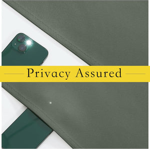 Close-up of dark green woven blackout fabric completely blocking light from a smartphone flash, assuring privacy.