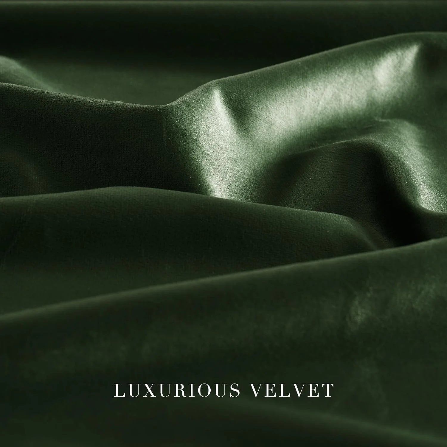 Close-up of dark green velvet fabric with soft folds and a lustrous sheen