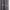 Close-up of dark grey blackout curtain showing smooth front and diagonally woven back fabric.