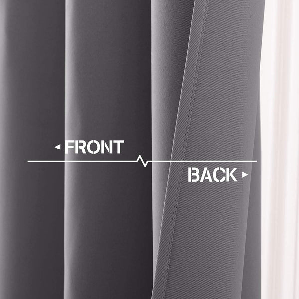 Close-up of dark grey blackout curtain showing smooth front and diagonally woven back fabric.