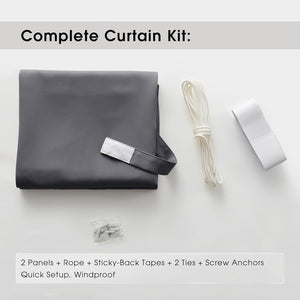 Complete dark grey blackout curtain kit laid flat, showing panels, white rope, sticky tapes, and anchors.