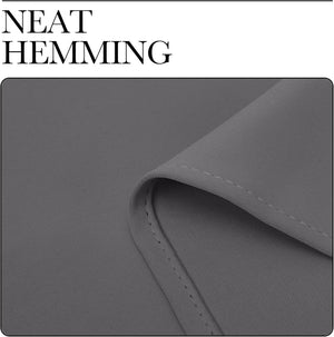 Close-up of dark grey fabric, likely a blackout curtain, highlighting the neat, even hemming with subtle diagonal texture.