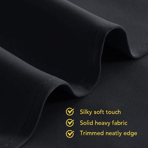 Dark grey fabric close-up with silky soft touch, solid heavy texture, and neatly trimmed edge.