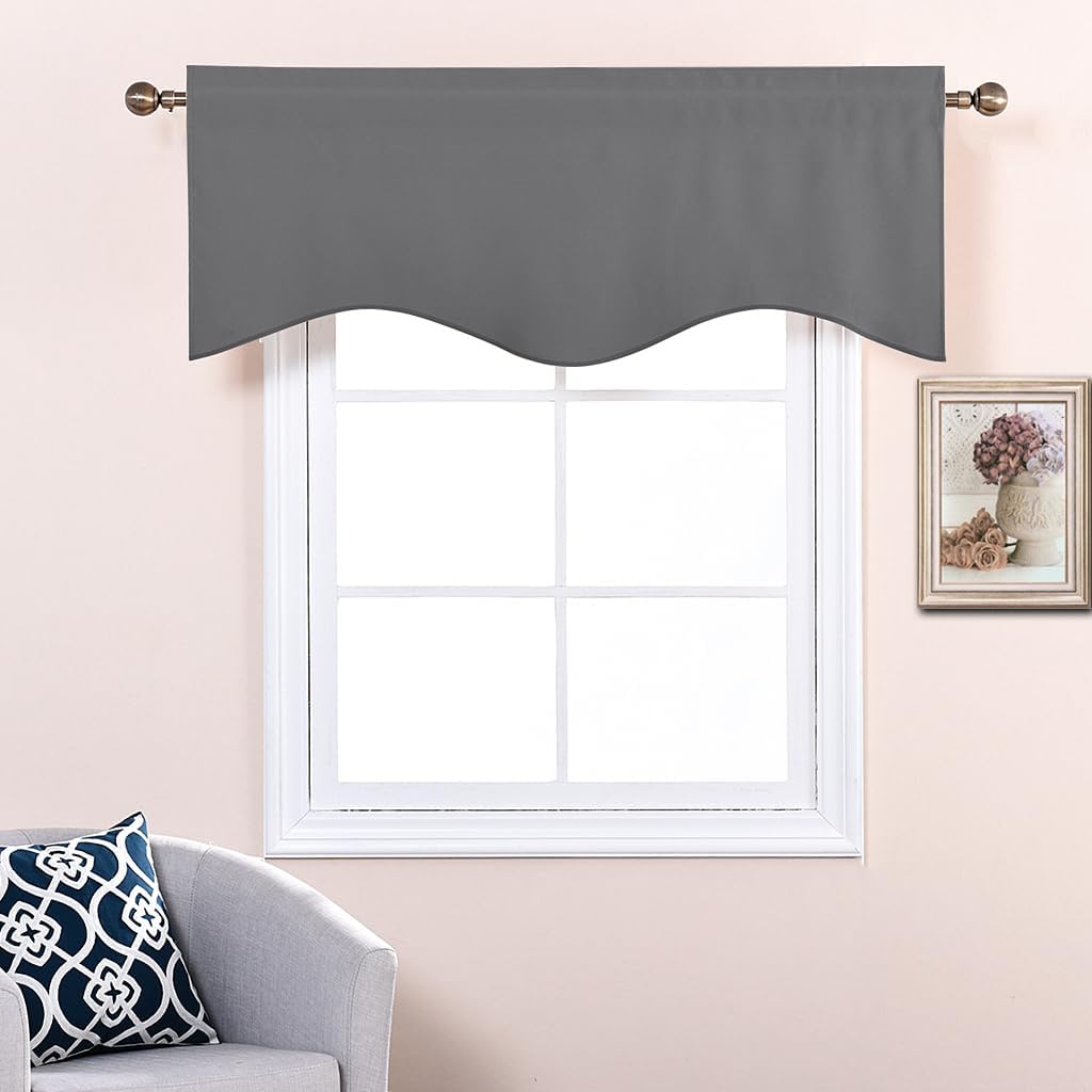 Charcoal grey valance with a wavy scalloped hem, hung on a decorative rod above a white window.